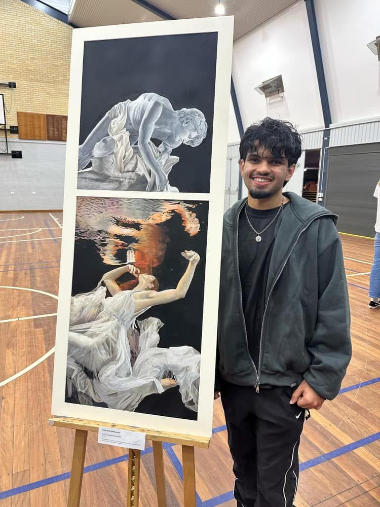 photo of student beside their artwork
