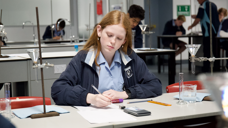 picture of a student recording experimental results