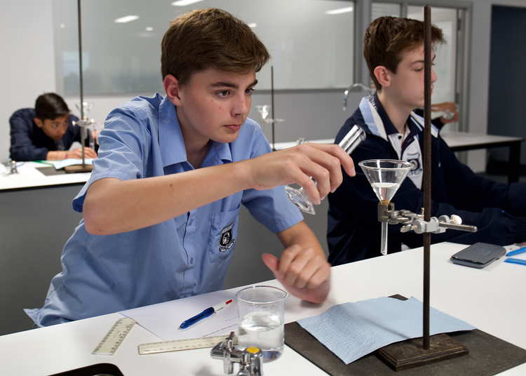 picture of student performing a science experiment