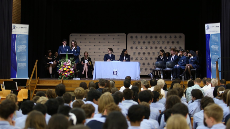 photo of the school prefects giving a presentation to their peers