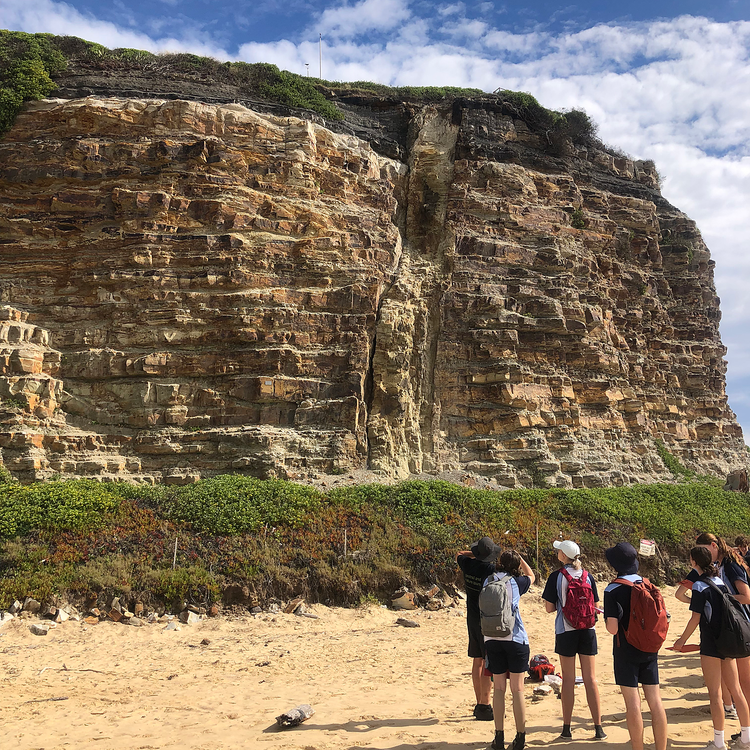 picture of students studying a geological structure